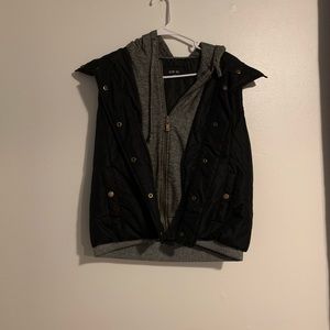 Black puff vest, grey liner, brown trim.